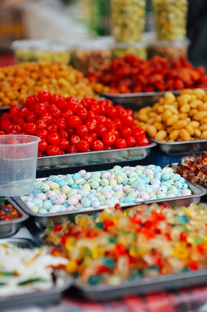 The Art of Drawing Readers In: Your attractive post title goes here Vibrant market stall showcasing assorted candies and dried fruits in trays.